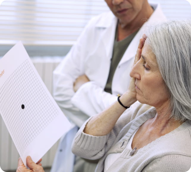 Optometrist consulting with an older patient about eye health and monitoring